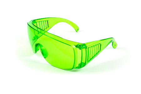 Green plastic protective spectacles isolated on white backgroundの写真素材