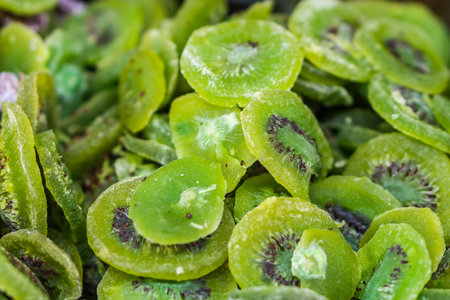 Heap of dried kiwifruit or Chinese gooseberry slice for retail sale in Thailand food market. It is fruit preserves for long-term storage.の写真素材