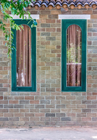Vintage brick wall and green wooden windows. The decoration for retro  interior design.の写真素材