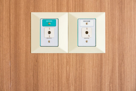 Oxygen and Vacuum pipeline on wooden wall. They are used in the patient room.