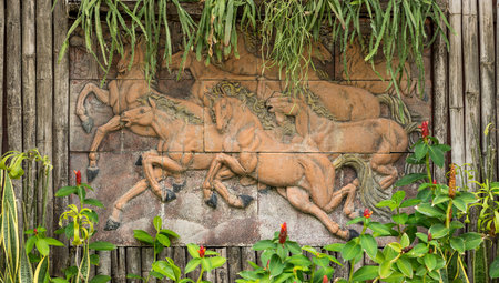 Running horses statue on bamboo wall. The design of exterior decoration.の写真素材