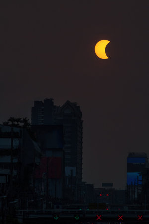 Maximum partial solar eclipse over building in  Bangkok city, Thailand, Asia. The Eclipse of the sun is on 9 March 2016 around 6.40 AM at local time.のeditorial素材