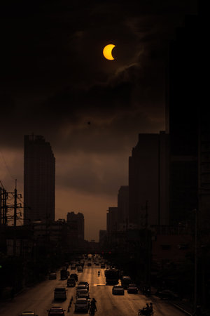 BANGKOK - MARCH 9, 2016: Partial and total solar eclipse over building in  Bangkok city, Thailand, Asia. The maximum partial Eclipse of the sun is on 9 March 2016 around 6.40 AM at local time.のeditorial素材
