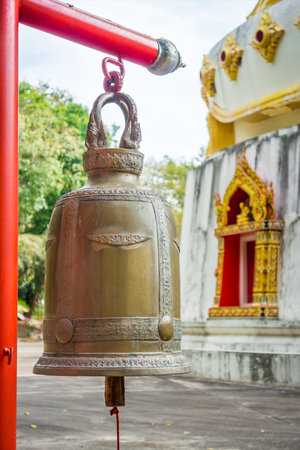 Big metal ritual bell in Thai Buddhist temple. This hanging bell is at Wat Pha Tung, Thailand, Asia.の写真素材
