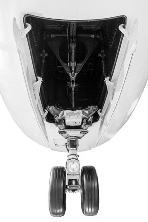 Landing gear system of an airplane. Wheels extend for landing from wheel well under an aircraft.の写真素材