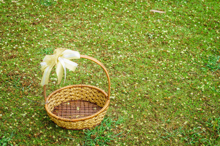 Empty gift basket on lawn. It is made of wood.