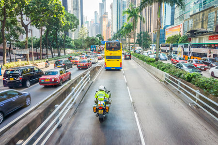 Hong kong police man with Traffic Branch BMW R900RT police motorcycle. He rides at Wan Chai, a busy commercial area on the northern shore of Hong Kong Island.のeditorial素材