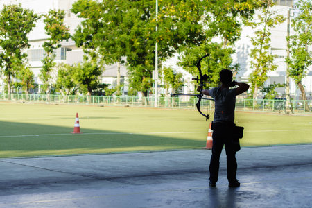 Archer is training with compound bow. It is outdoor archery sport.の写真素材