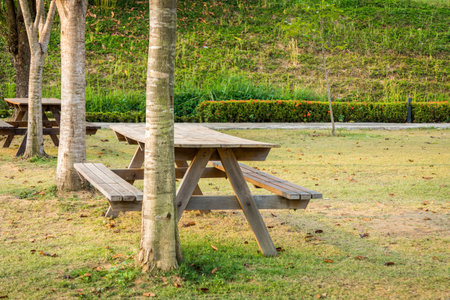 Wooden table sets with built-in bench in a garden. They are also called outdoor furniture.