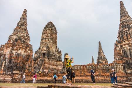 AYUTTHAYA, THAILAND - MARCH 7, 2018: Tourists are touring in Wat Chaiwatthanaram ruins. It is an old Buddhist temple in Ayutthaya Historical Park.のeditorial素材