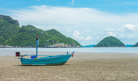 Vintage Thai fishing boat anchored on Bang Pu beach. Seascape view of the Gulf of Thailand from Prachuap Khiri Khan province.の写真素材