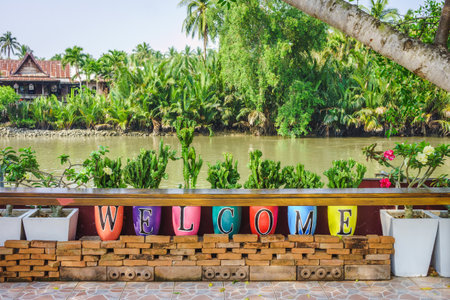 Colorful welcome alphabets on potteries at riverside. They are near river in countryside of Thailand.の写真素材