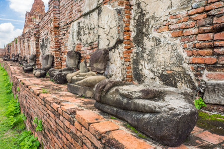 Remains statues of sitting Buddha image at Wat Mahathat. The old Buddhism ruins in Ayutthaya, Thailand, Southeast Asia.の写真素材