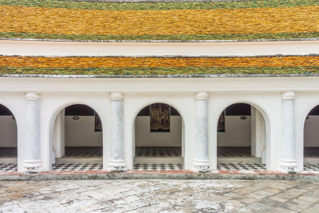 Buddhist religion architecture with corridor of Wat Phra Pathommachedi Ratcha Wora Maha Wihan. This temple is in Nakhon Pathom, Thailand, Southeast Asia.の写真素材