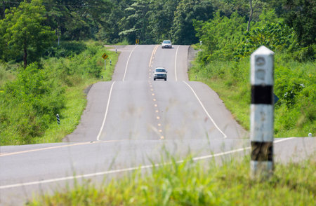 Two vehicles on hilly road. Location in rural area of Thailand, Southeast Asia.の写真素材