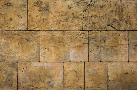 Rectangular yellow dry stone block wall. It was constructed from stones without any mortar to bind them together.の写真素材