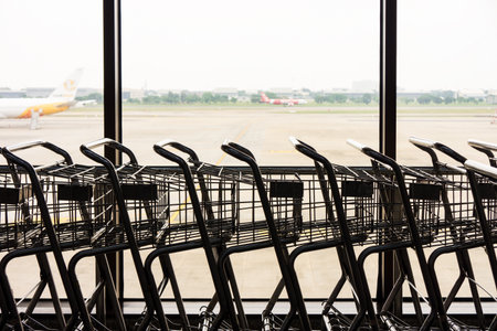 Closeup of silhouette of baggage carts. They are provided in airports for transporting luggage.の写真素材