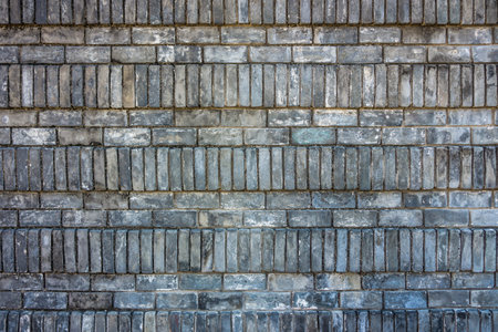 Old gray brick wall constructed in stretcher and soldier bond. There are two decorative pattern of alternating courses.の写真素材