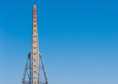 Side view of giant ferris wheel with copy space. Massive amusement ride with multiple passenger cars.の写真素材