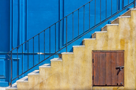 External stairway of vintage blue building. Staircase consists of metal handrails, marble steps treads and under stairs storage.の写真素材