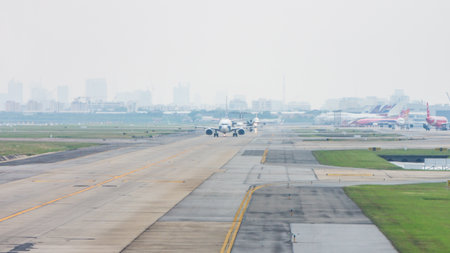 BANGKOK - OCT 26, 2019: Airplanes on taxiway in Don Mueang International Airport, Thailand. The path way for aircraft transfer to and from runway.のeditorial素材