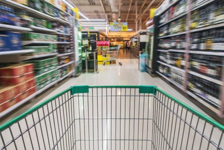 Shopping cart in beverage department. It is also known as trolley or wheeled cart.の写真素材