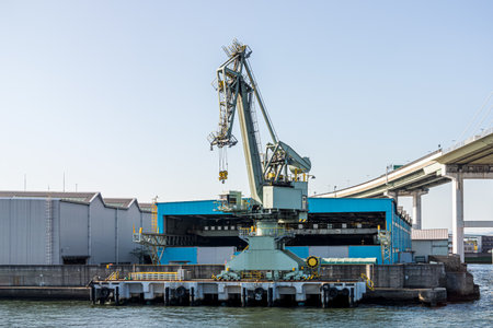 Crane and factory at seaside. This area is located at Osaka port in Japan.のeditorial素材