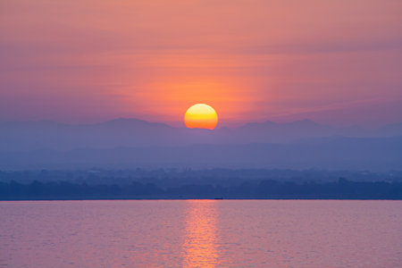 Natural landscape view of sunrise behind mountain range. Scenery of Pa Sak Chonlasit reservoir, Lopburi province, Thailand.の写真素材