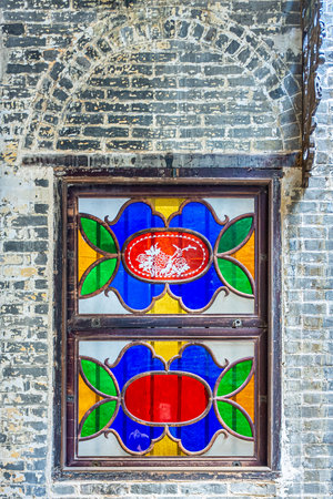 Colorful glass window of Lou Kau Mansion built with Portuguese decoration and Chinese architecture style. The old house is a historical building in SÃ©, Macau, China.の写真素材