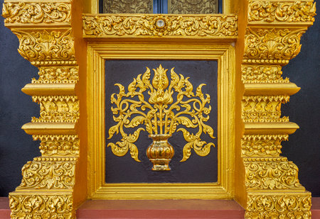 Religion art Lanna style of Thai Buddhism on outside temple wall of Wihan Somdet Ong Pathom. The beautiful design at at Wat Phra That Doi Phra Chan.  The building is on the top hill of Doi Phra Chan mountain in Mae Tha, Lampang, Thailand.の写真素材