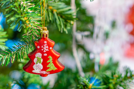 Red bauble decorated on Christmas tree. Ornamented decoration are used to festoon artificial Xmas tree.の写真素材