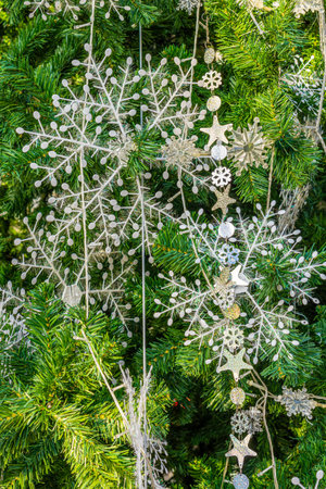 Christmas ornaments on decorated artificial tree. Xmas baubles and other decorations are used to festoon the celebration.の写真素材