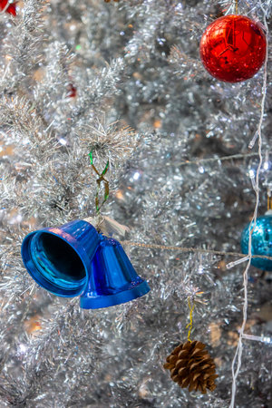 Blue Christmas toy bells on artificial tree. Xmas baubles decoration are used to festoon the celebration.の写真素材