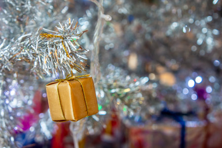 Christmas toy gift box on tree. Xmas bauble decoration are used to festoon the celebration.の写真素材