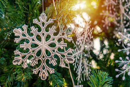 Plastic Christmas ornaments on artificial tree. Xmas baubles and other decorations are used to festoon the celebration.の写真素材
