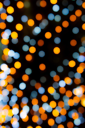 Abstract small circular bokeh background of Christmaslight,abstract background. Colorful blurry Christmas lights ornament at night.の写真素材