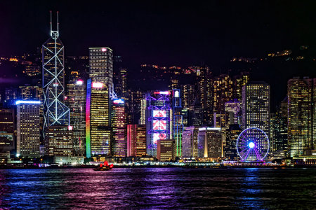 Cityscape of Hong Kong Victoria Harbour at Night. Mesmerizing beauty of Hong Kong's Victoria Harbour at night, showcasing the dazzling illuminated skyline and reflections on waterの写真素材