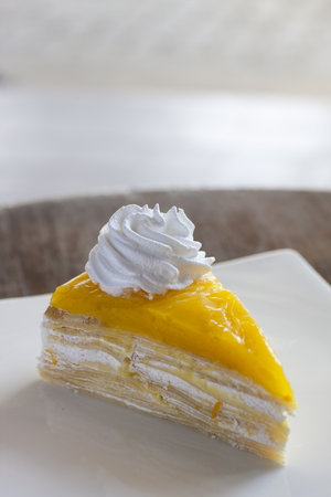 Orange Crepe Cake on the White dish.の写真素材