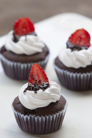 Chocolate Cupcake with strawberry on White dishの写真素材