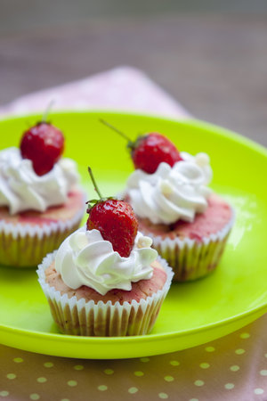 Strawberry cupcake with Strawberry On a green dish.の写真素材