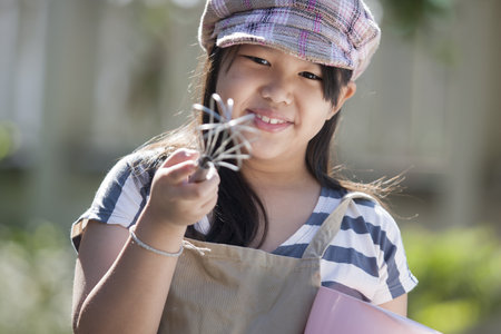 Cute asian girls enjoy playing cookingの写真素材