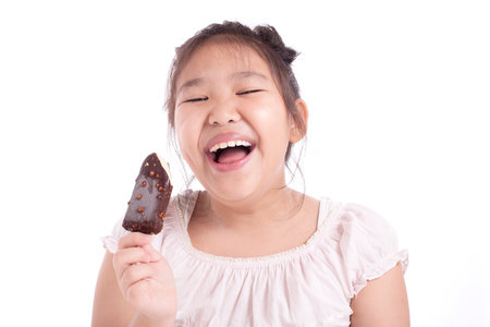 Little asian girl happy with eating ice creamの写真素材