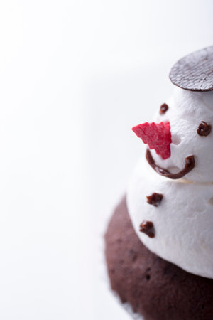 Christmas cupcake decorated with a whipped cream snowmanの写真素材