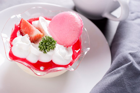 Tiramisu Dessert with Strawberry  and Macaron on white dish 