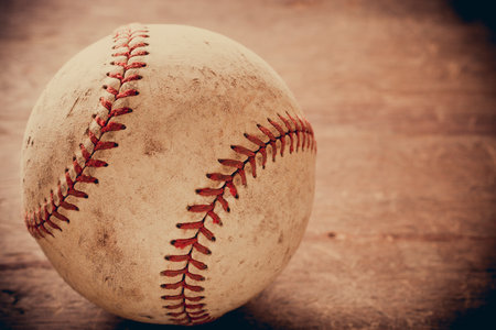 Old baseball on wooden background and highly closeupの写真素材
