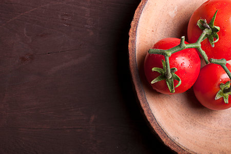 Tomatoes on the wood background with text spaceの写真素材
