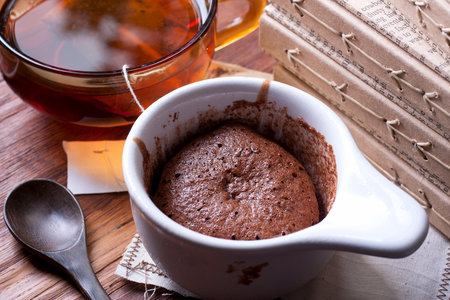 Chocolate mousse served in a white cup  with a cup of teaの写真素材