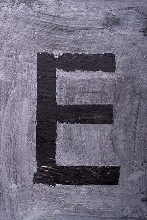 Black grunge alphabet sticky tape effect.Letter Eの写真素材
