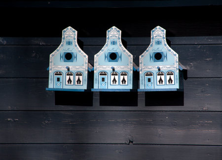 The Hague,Netherlands february-18-2015 three bird houses on a wooden wall. the bird houses have the shape of a typicall 17 century dutch houseの写真素材