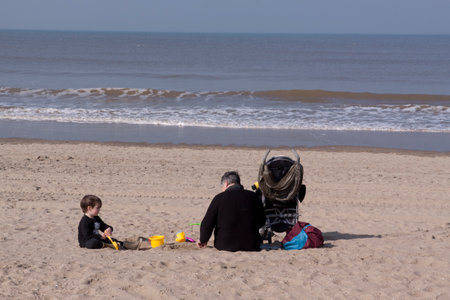 Scheveningen,The Netherlands-march 17,2015: Dad and son playing on the beach at scheveningen and enjoying the spring sumのeditorial素材